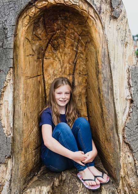 child portrait photographed inside of a tree in Jephson Gardens, Leamington Spa UK