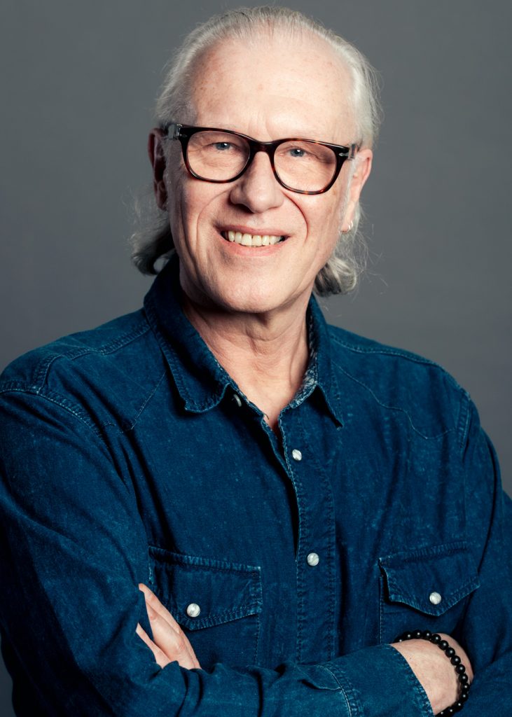 Smiling author headshot with soft, flattering studio lighting